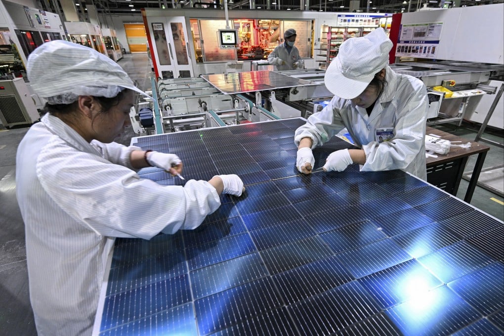 Workers inspect solar panels at a factory in China’s eastern Jiangsu province. Photo: AP