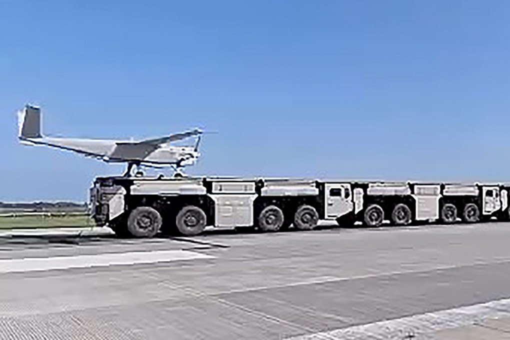 A drone is launched from an electromagnetic catapult system using interconnected trucks that form a continuous platform. Photo: BIT/WeChat