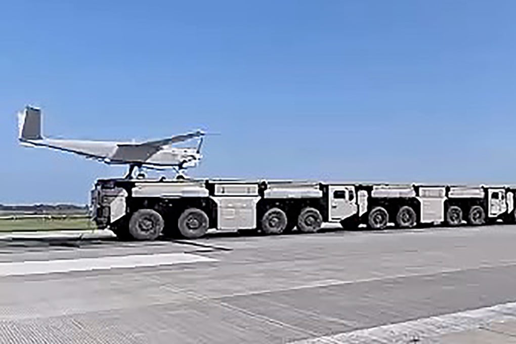 A drone is launched from an electromagnetic catapult system using interconnected trucks that form a continuous platform. Photo: BIT/WeChat