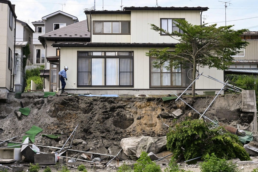 A man checks a retaining wall that collapsed by the earthquake in Hachinohe, Aomori prefecture, on June 25. Photo: Kyodo