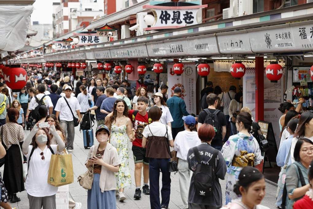 Tourists throng a shopping street in the popular Asakusa district of Tokyo on June 22. Photo: Kyodo