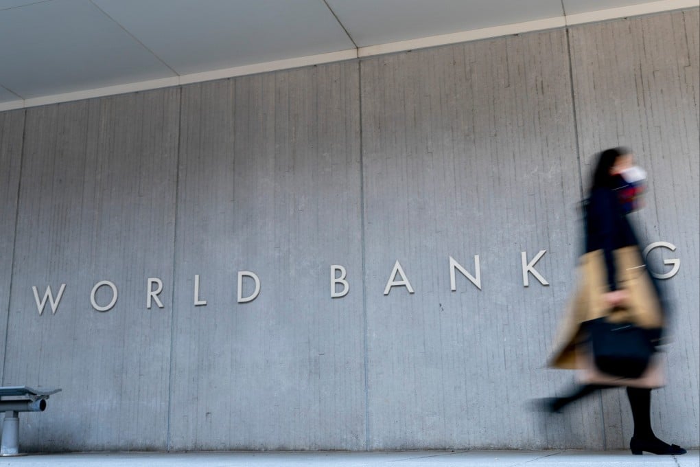 A woman walks by the World Bank building in Washington. The World Bank will reportedly cap sovereign lending to China at US$2 billion for the 2026-2031 period before ending it altogether. Photo: AP