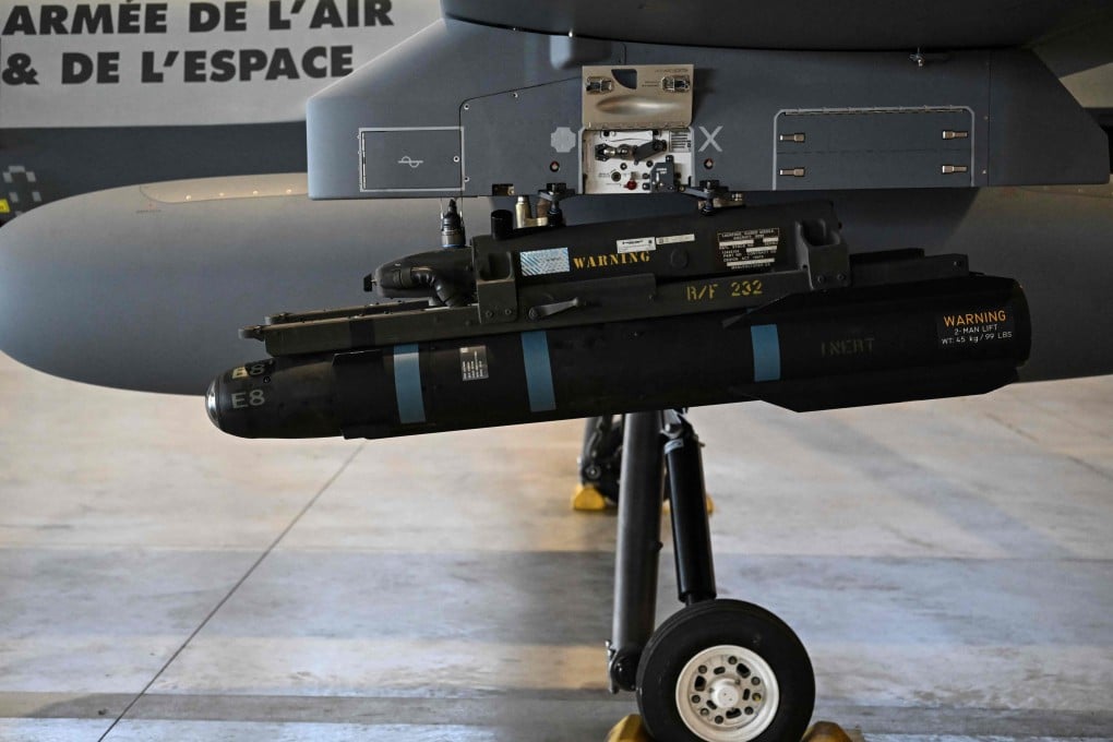 A  model of a Hellfire missile is seen attached under the wing of an MQ-9 Reaper military drone during a demonstration on June 12. Photo: AFP