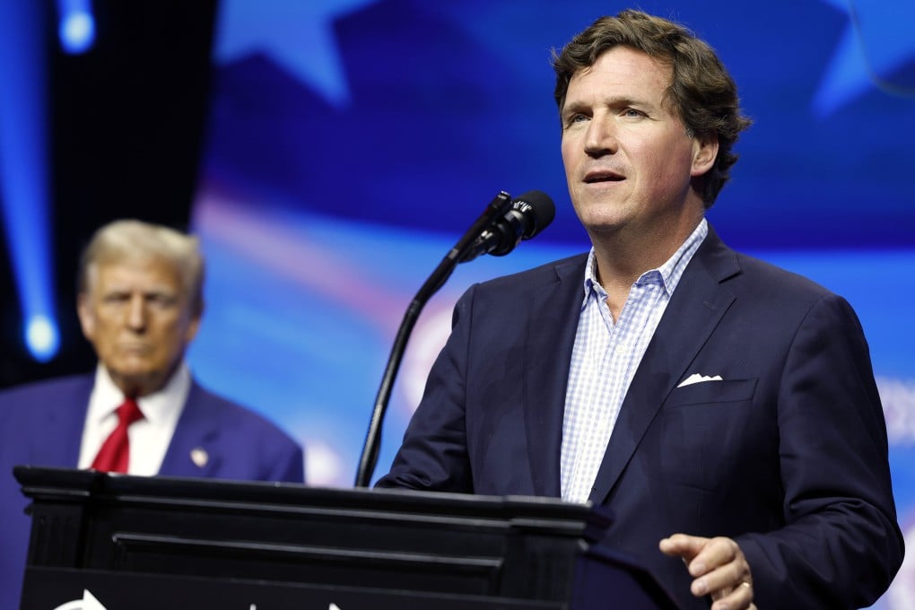 Political commentator Tucker Carlson speaks alongside then Republican presidential nominee Donald Trump during a rally on in October 2024 in Georgia. President Trump’s handling of the Iran war and the economy continue to divide the conservative movement. Photo: TNS
