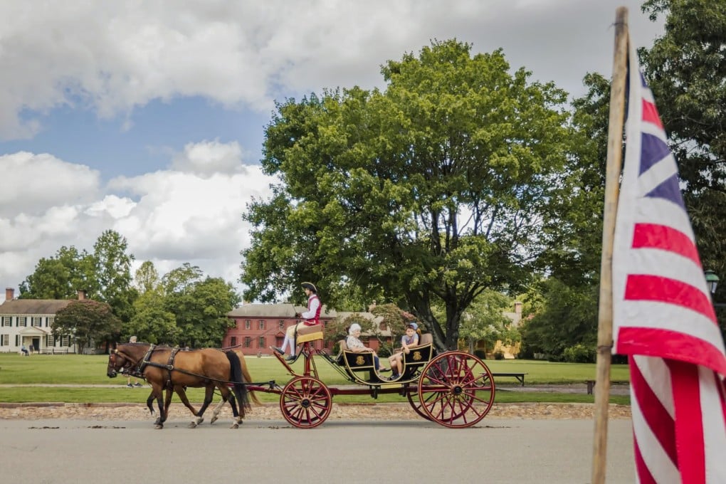 A horse-drawn carriage takes visitors around Colonial Williamsburg, in Virginia. Photo: Getty Images