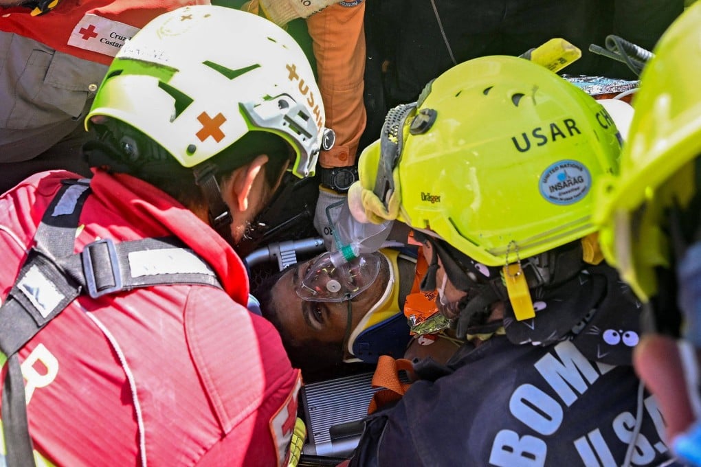 Hernan Gil after his rescue from the rubble on Thursday. Photo: AFP