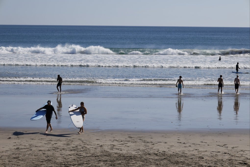 Tourists spend time at a beach in Kuta, Bali, Indonesia, on Wednesday. Photo: EPA