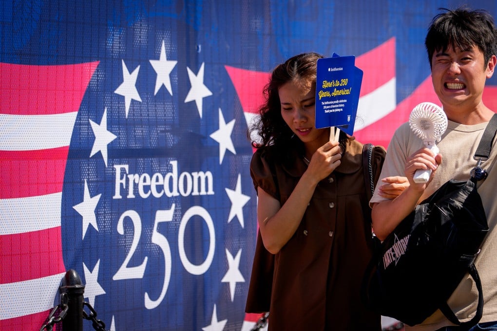 Visitors try to stay cool as they walk along the National Mall on Friday as the country celebrates America’s 250th anniversary in Washington. Photo: TNS