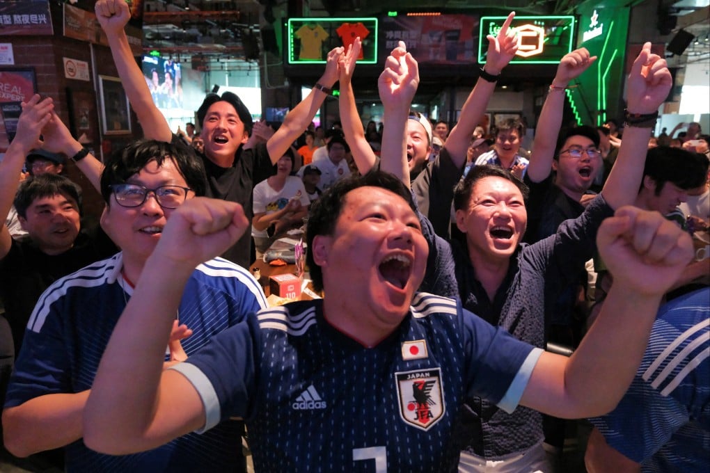 Fans in Shanghai cheer during a Fifa World Cup match between Japan and Tunisia on June 21. Japan won 4-0 but were later knocked out of the tournament. Photo: Reuters