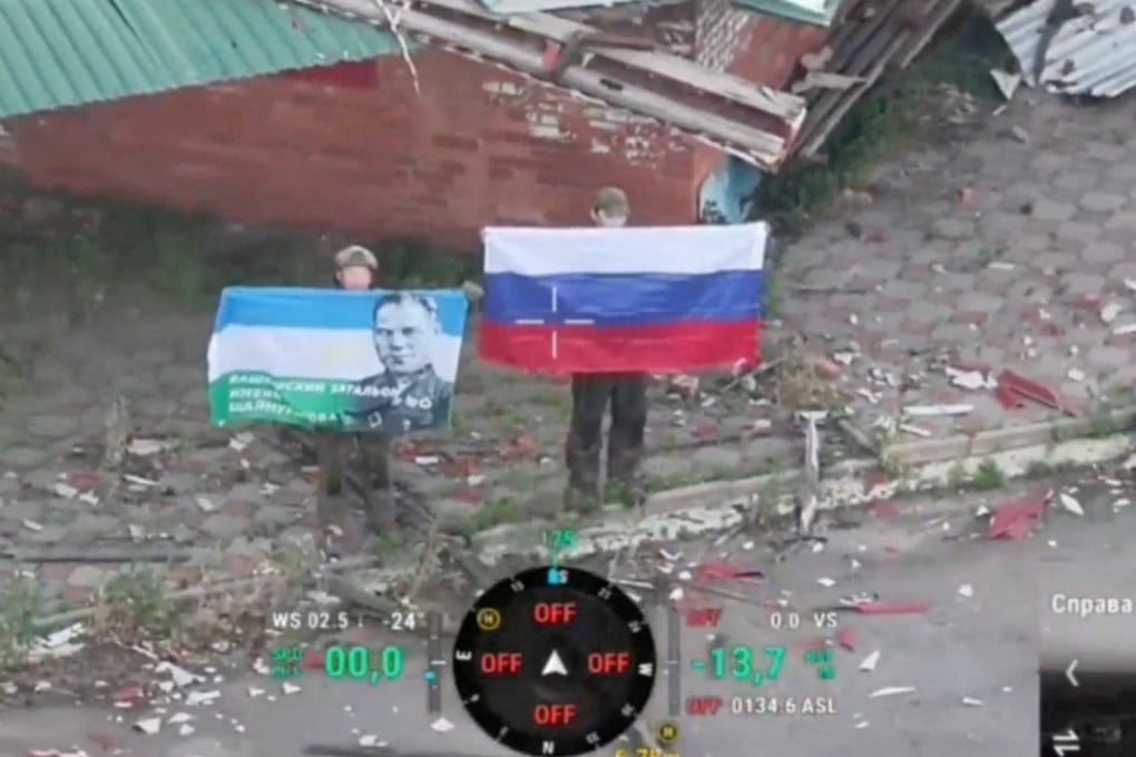 A drone view shows soldiers, with one holding up a Russian flag, as the Russian defence ministry says its forces have taken control of Kostiantynivka, in Ukraine’s Donetsk region. Photo: Russian Defence Ministry via Reuters