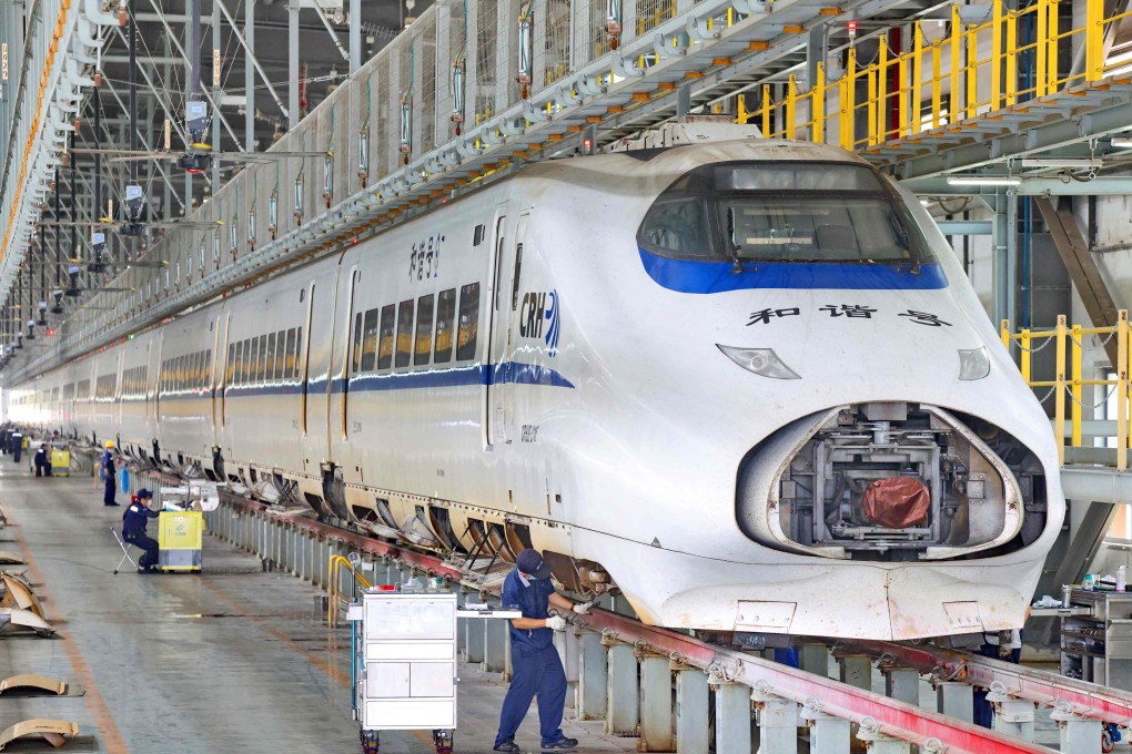 Workers examine a high-speed train at a depot in Nantong, in eastern Jiangsu province, on June 29. Photo: AFP