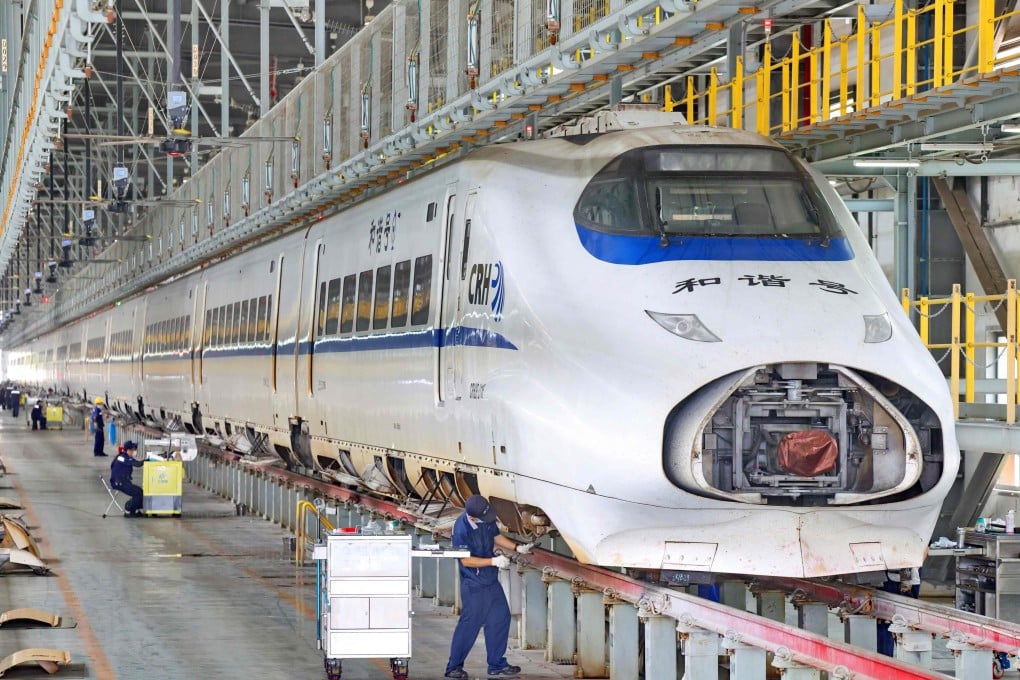 Workers examine a high-speed train at a depot in Nantong, in eastern Jiangsu province, on June 29. Photo: AFP