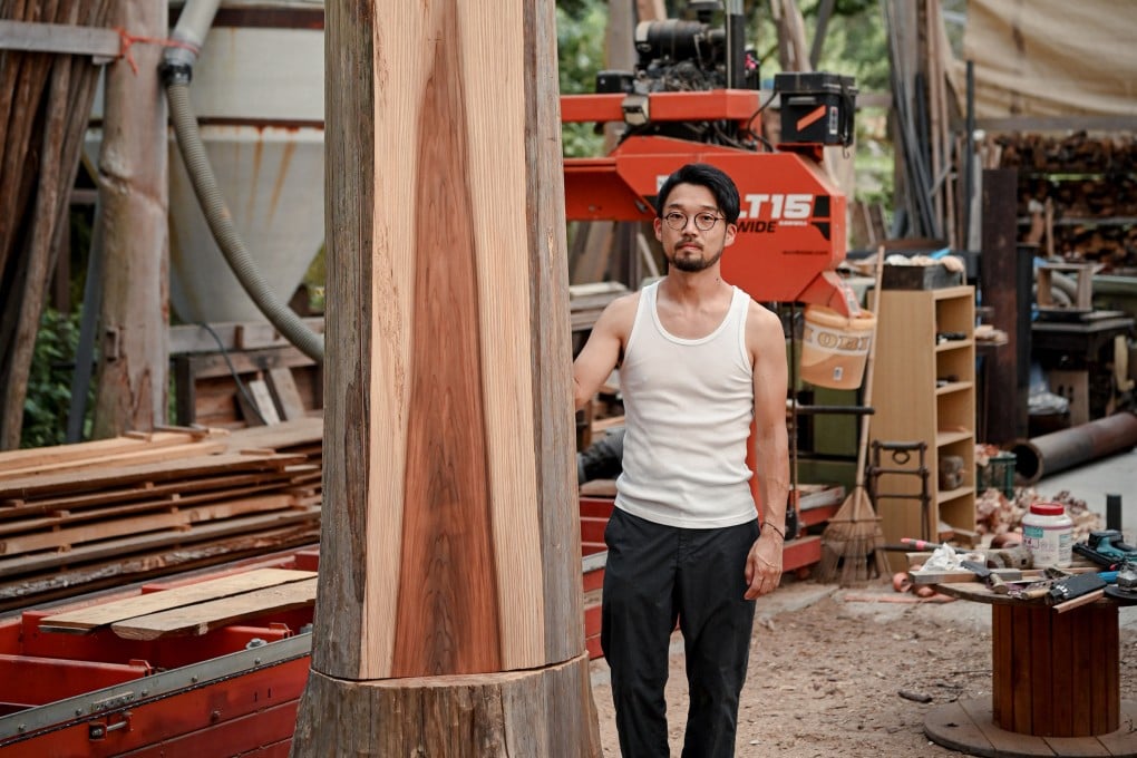 Shinya Kobayashi beside a cedar, the wood he uses as much as possible
in the construction of his “village”. Photo: courtesy Mujun