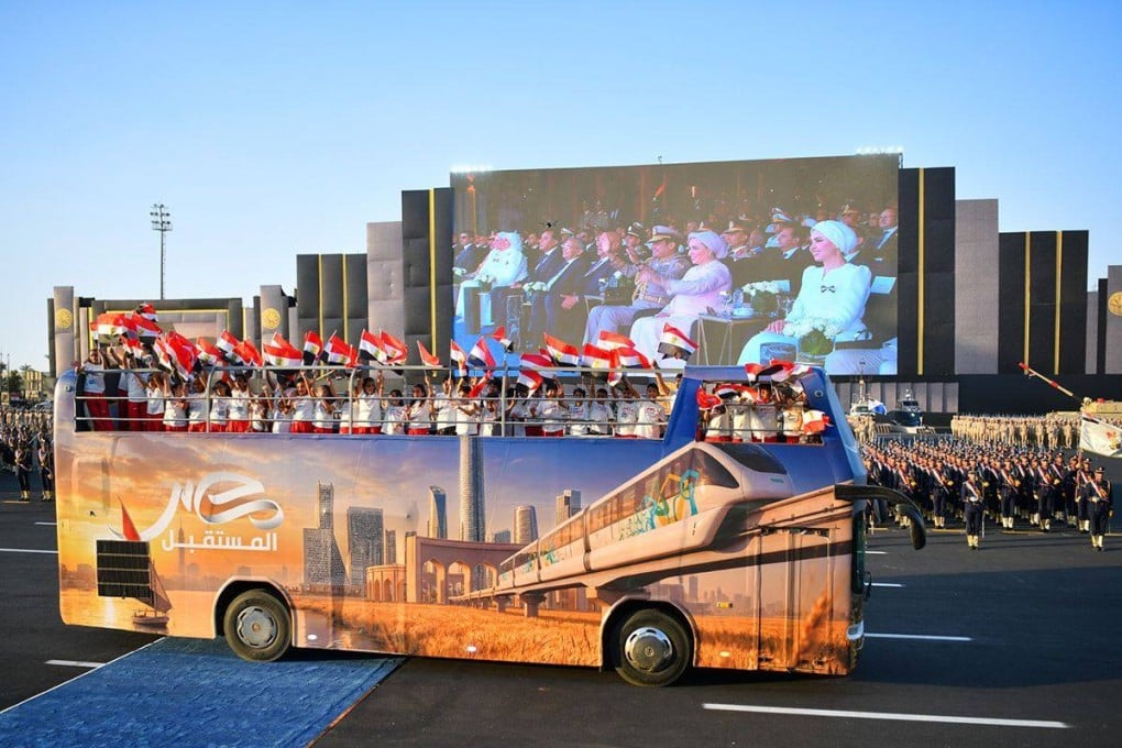 An open-top bus carrying a group of children passes The Octagon military headquarters near Cairo, Egypt. Photo: Egyptian Presidency / dpa