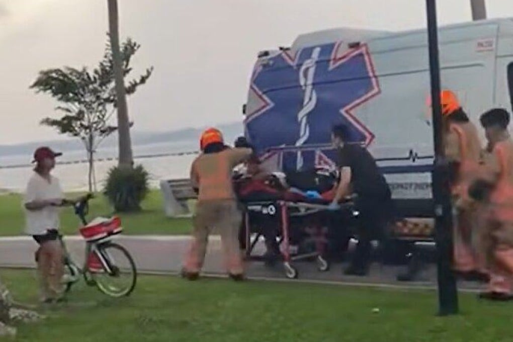 Rescuers rush a person to an ambulance at Pasir Ris Beach on Sunday. Photo: TikTok/singaporeincidents.sg