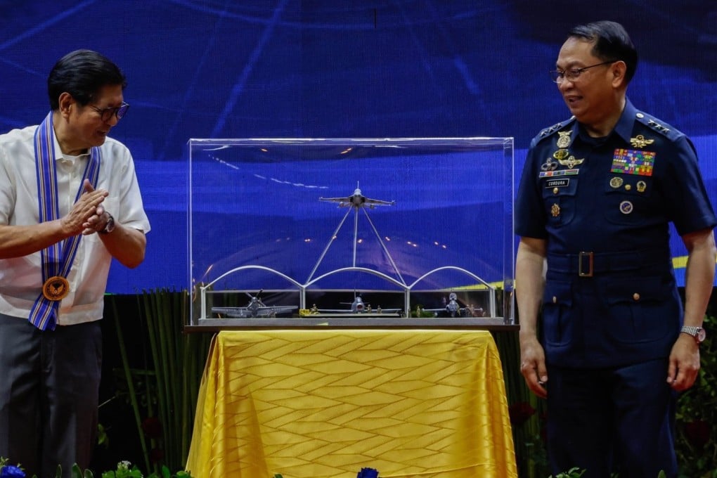 Philippine President Ferdinand Marcos Jnr looks at miniature models of military aircraft presented to him by air force chief Lieutenant General Arthur Cordura (right) during an event at Villamor Air Base in Pasay City on July 1 marking the Philippine Air Force’s 79th founding anniversary. Photo: EPA