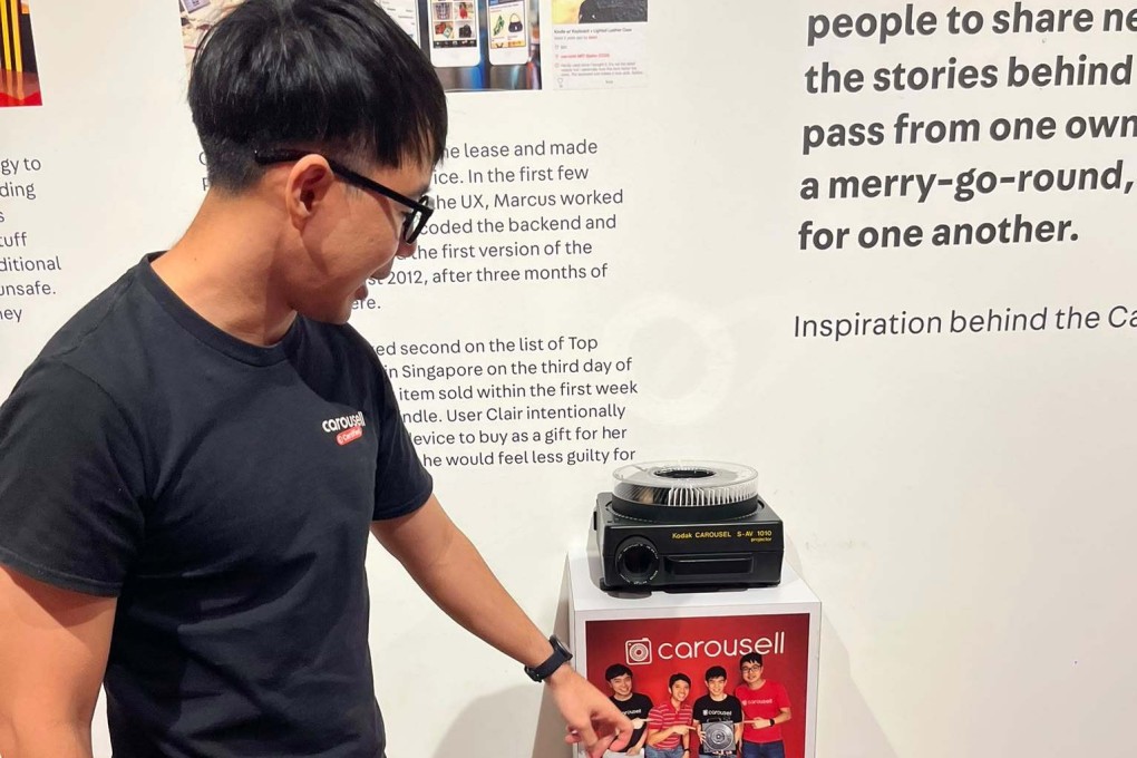 Carousell co-founder Marcus Tan points to a Kodak carousel projector, gifted to them by a platform user, on display in the company’s Singapore office. Photo: Jean Iau