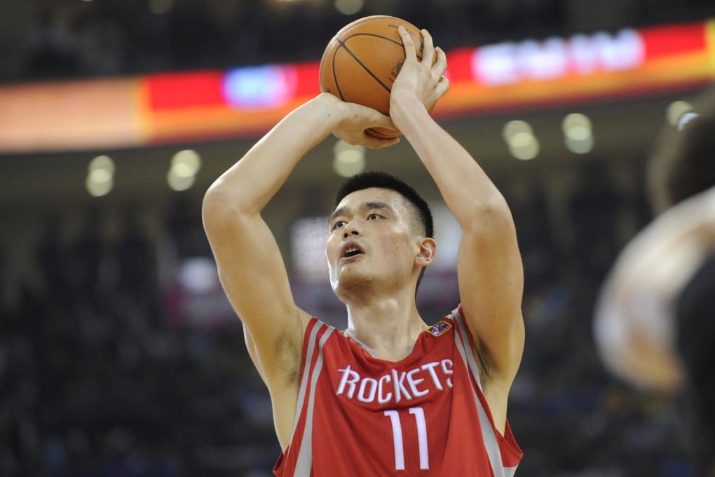 Yao Ming, then playing for the Houston Rockets, makes a free throw during an NBA China Games match against the New Jersey Nets on October 13, 2010. File photo: AFP
