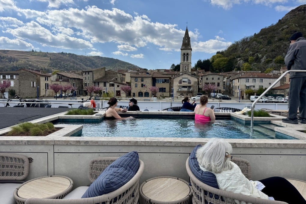Passengers soak in the pool onboard the Lumiere riverboat while soaking up views of Andance, a pretty village along the Rhone River, in France. Photo: TNS