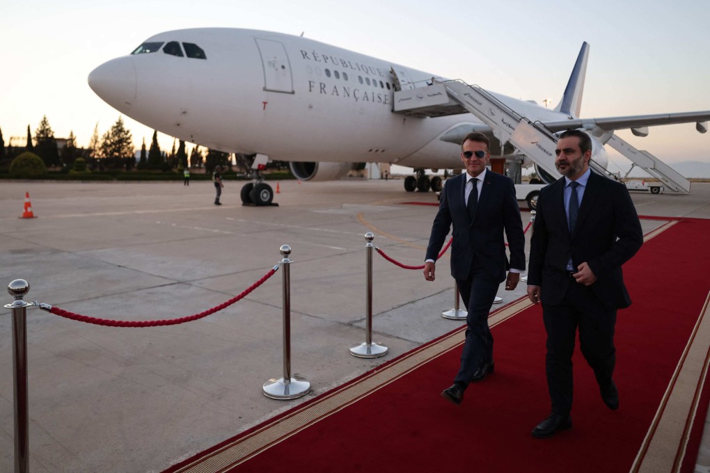 French President Emmanuel Macron, left, is welcomed by Syria’s Foreign Minister Asaad al-Shaibani at Damascus International Airport on Monday. Photo: AFP
