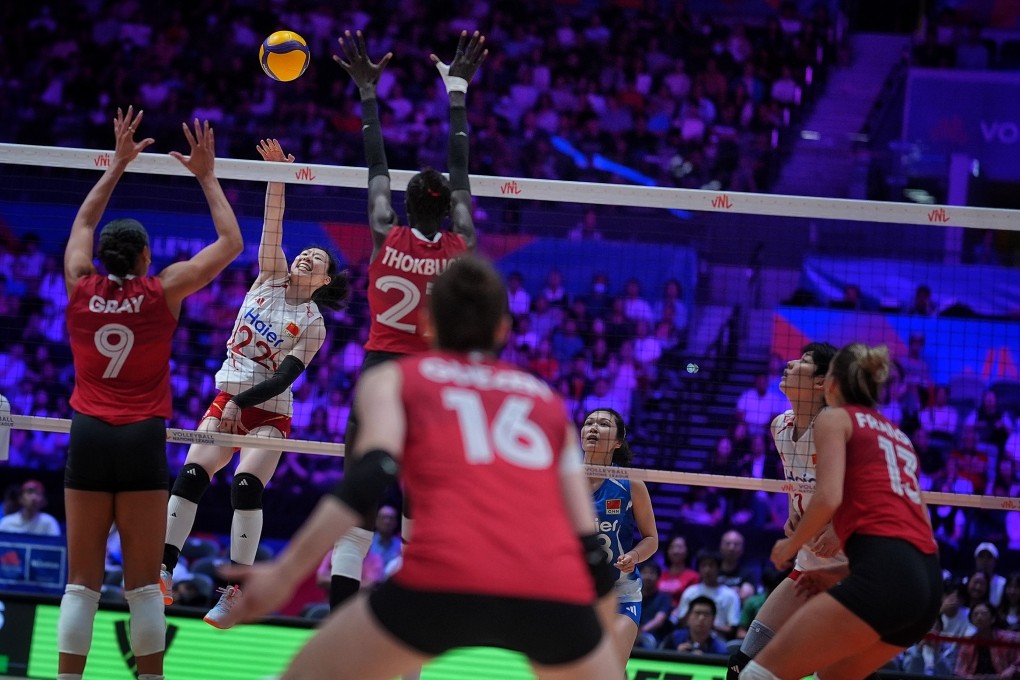 China’s Zhou Yetong (left, in white) hits a spike against Canada on the first day of Volleyball Nations League Hong Kong at Kai Tak Sports Park. Photo: Elson Li