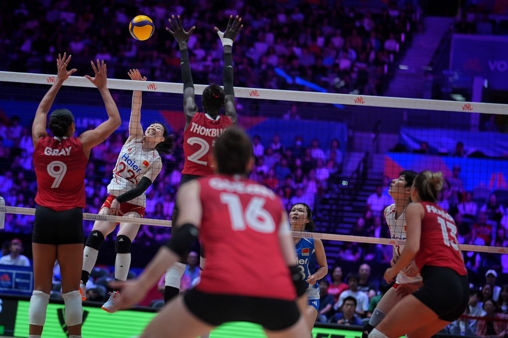 China’s Zhou Yetong (left, in white) hits a spike against Canada on the first day of Volleyball Nations League Hong Kong at Kai Tak Sports Park. Photo: Elson Li