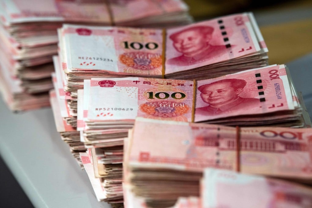 Bundles of 100 yuan notes at a bank in Shanghai. China’s latest five-year plan includes having Hong Kong play an increased role as an offshore yuan hub. Photo: AFP