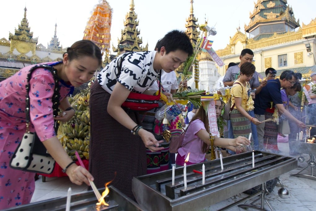 Tourists offer joss sticks at Myanmar’s Shwedagon Pagoda in Yangon in 2019. Photo: AP
