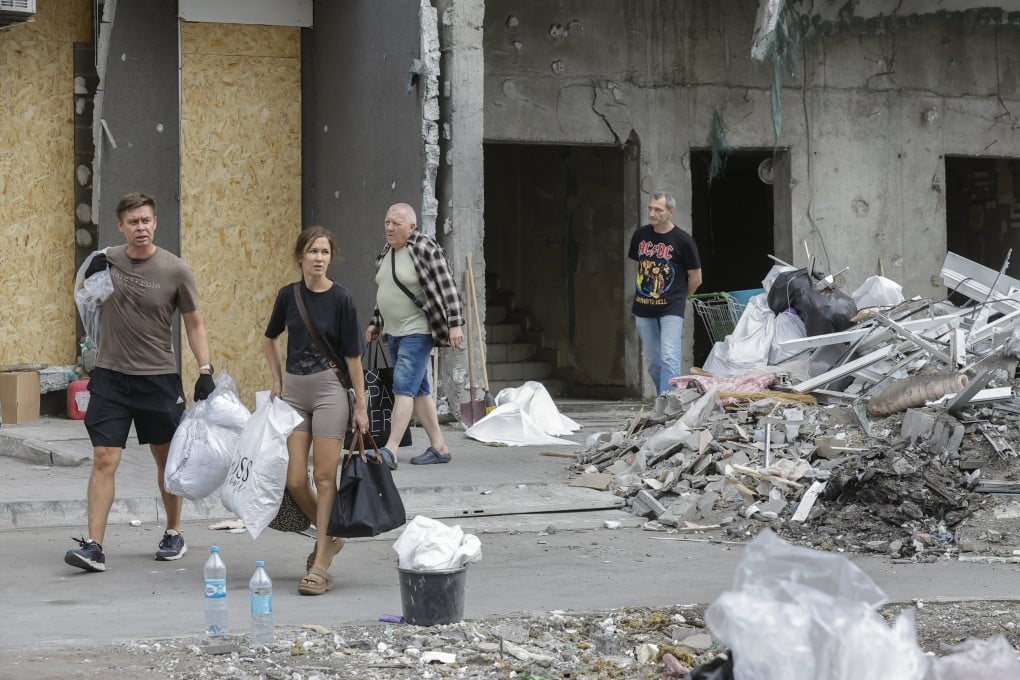 Local residents salvage belongings from their damaged flats at the site of a Russian strike in Kyiv on Tuesday. Early on Wednesday, a further barrage rocked the Ukrainian capital. Photo: EPA