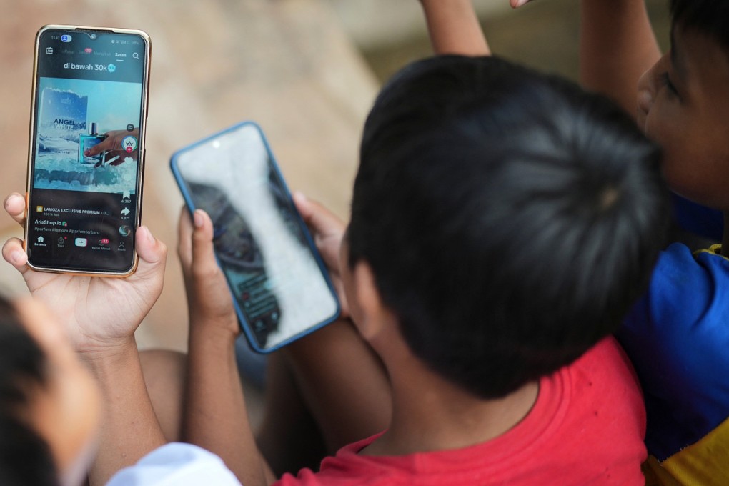 Boys use their mobile phone in Jakarta on April 29. Photo: AP