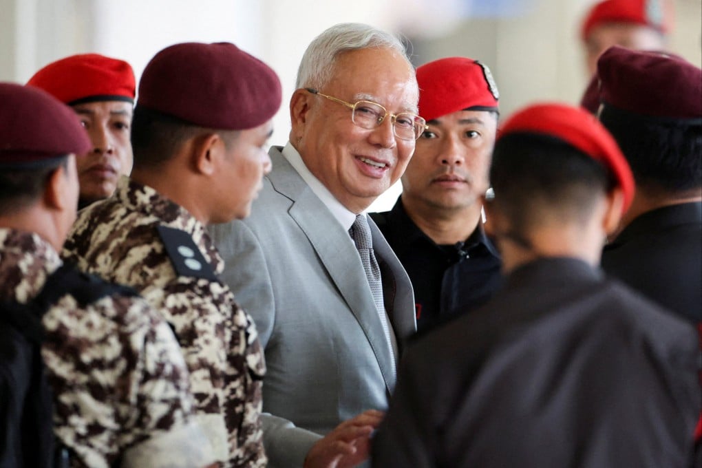 Malaysia’s former prime minister Najib Razak, jailed for corruption in the multibillion-dollar 1MDB scandal, is escorted by prison guards at Kuala Lumpur Courts Complex in 2025. Photo: Reuters