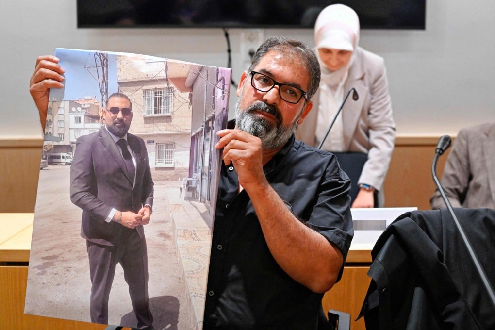 Erdal Calar, father of the dead train attendant Serkan Calar, holds a picture of the victim in the courtroom of the Regional Court of Zweibruecken, western Germany last month. Photo: AFP