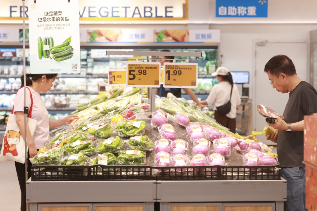 Customers buy vegetables at a supermarket in Wuhan, Hubei province, last month. Photo: Xinhua