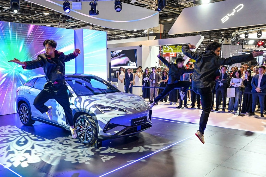 Practitioners perform martial arts next to a BYD electric car during a motor show in Singapore last year. Photo: AFP
