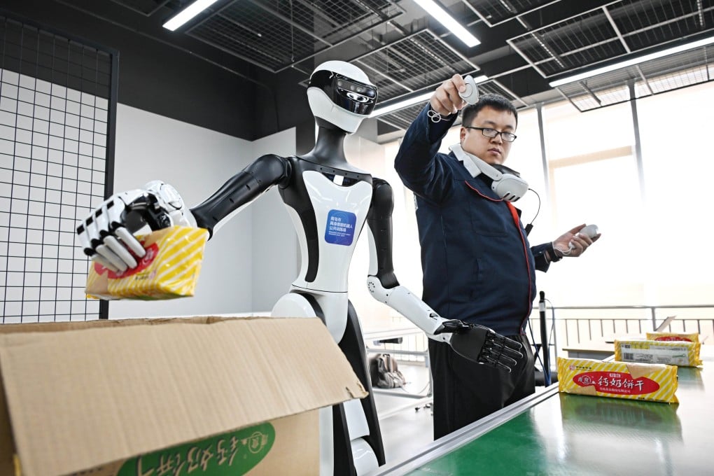 A worker supervises the training of a humanoid robot in Qingdao, Shandong province, on April 22. Photo: Xinhua