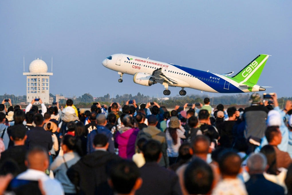 A crowd watches as China's domestically produced C919 passenger jet takes off at an air show in Nanchang, central Jiangxi province, on November 2, 2024. Photo: AFP
