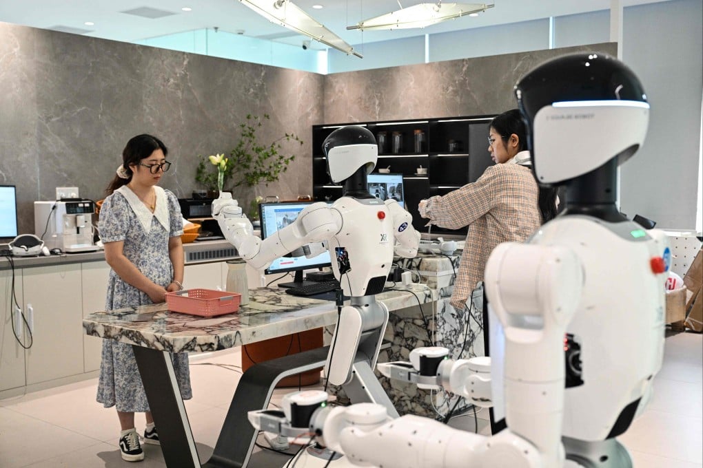 An engineer trains a humanoid robot to do household tasks at an X Square Robot facility in China’s Guangdong province. Photo: AFP