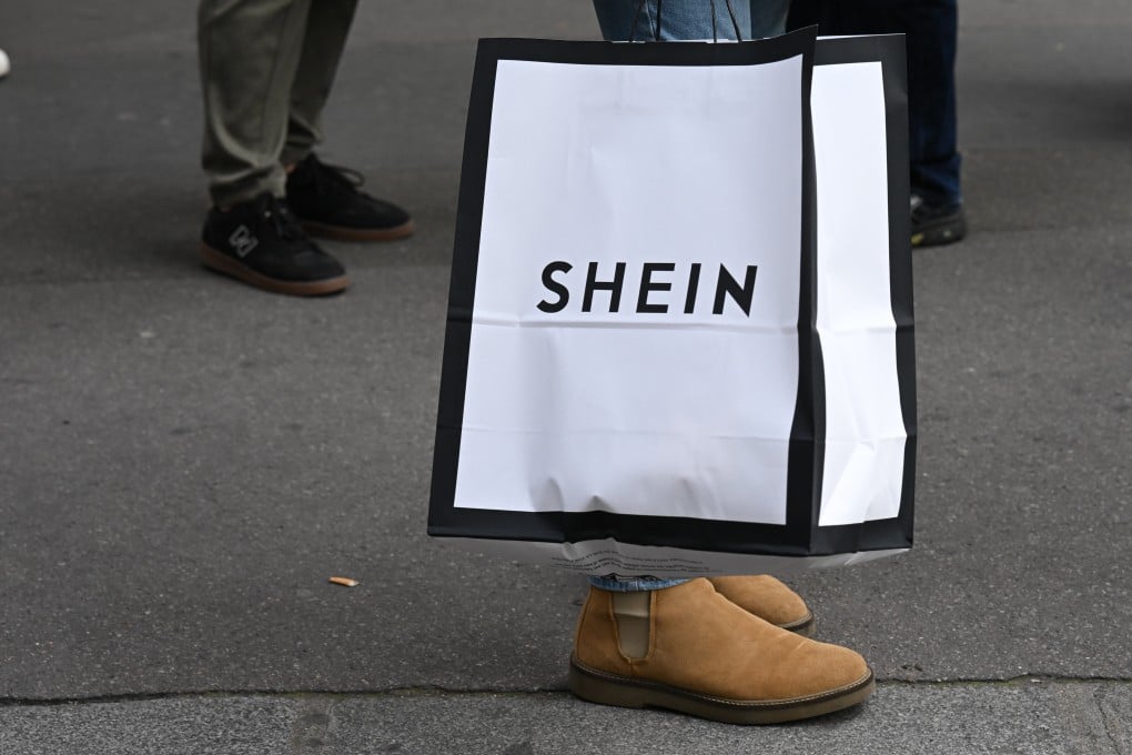 Customers carrying bags of shopping leave the Shein store in Paris in November. Photo: dpa