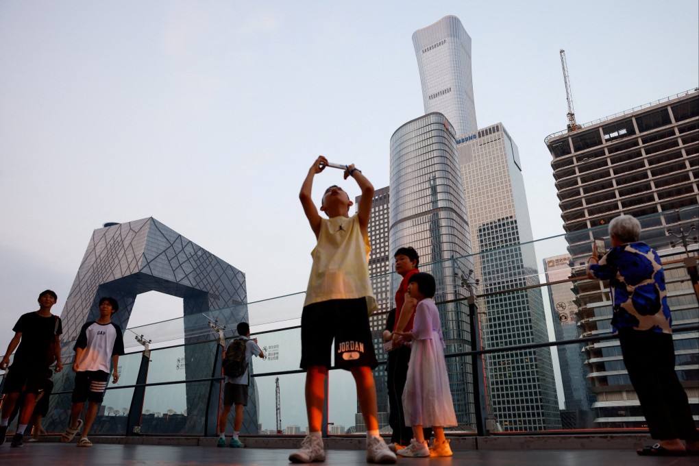 People visit a terrace of a shopping mall overlooking the central business district in Beijing on August 11, 2025. Photo: Reuters