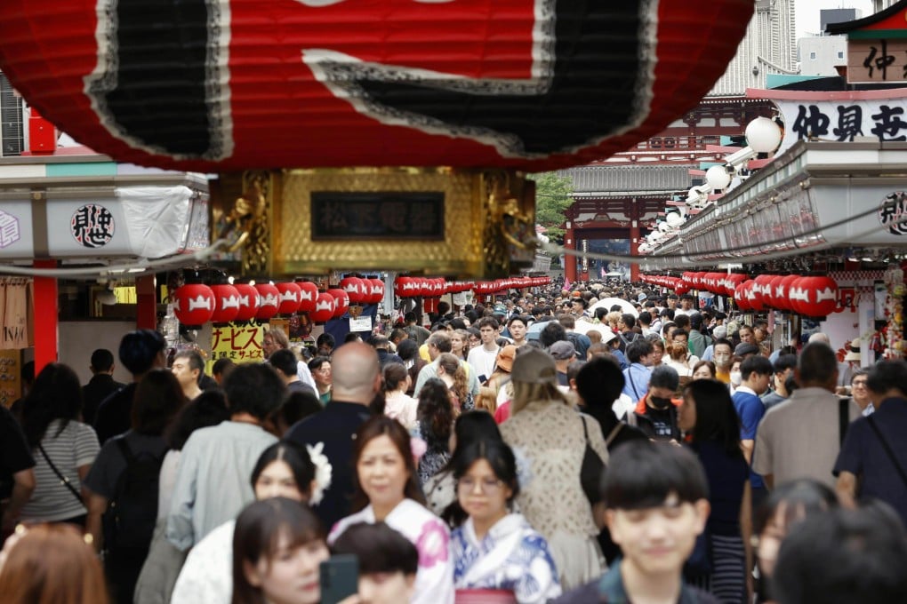 Tourists throng a shopping street in front of Sensoji Temple in the popular Asakusa district of Tokyo, Japan, last month. Photo: Kyodo
