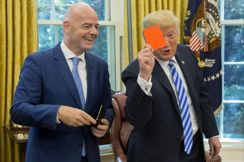 US President Donald Trump holds up a Fifa red card that bears his name, given to him by the association’s president Gianni Infantino (left) during their meeting at the White House in Washington on August 28, 2018. File photo: EPA-EFE