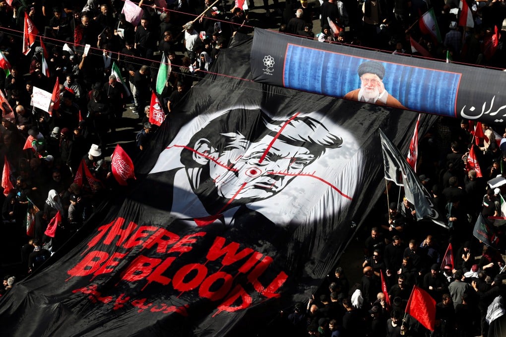 Mourners carry an anti-Trump banner in Mashhad, Iran, on thursday. Photo: WANA via Reuters