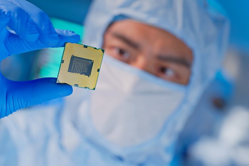An engineer examines a chip in a factory. Photo: Shutterstock