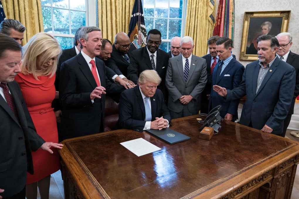 US President Donald Trump and faith leaders pray at the White House in 2017. Photo: AFP