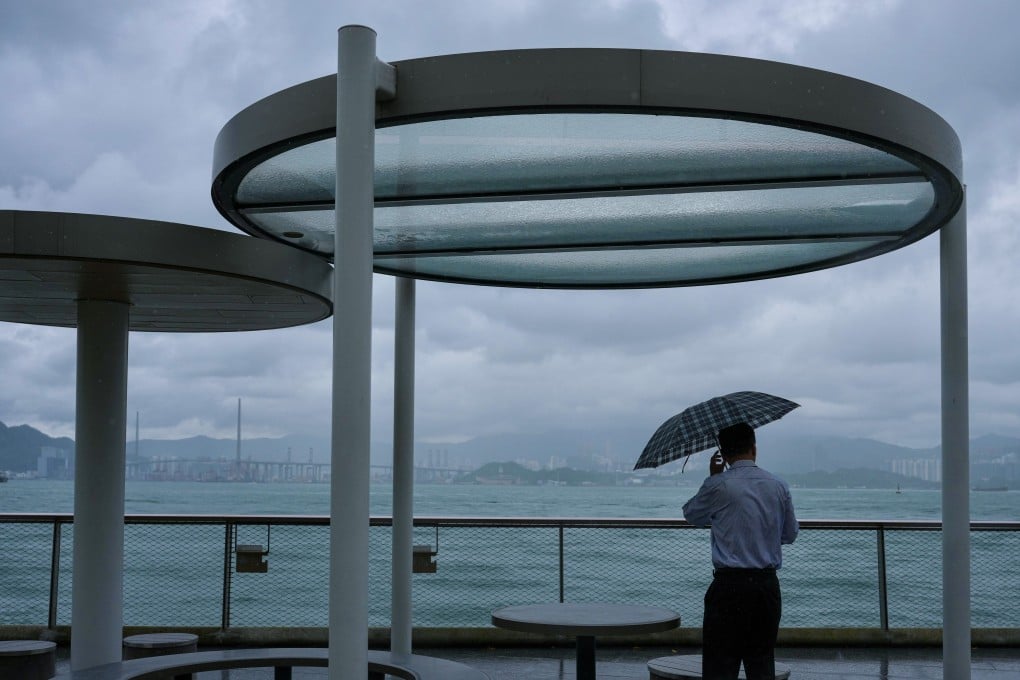 Cloudy skies over Hong Kong harbour as a resident takes shelter at Sai Ying Pun Harbourfront Park. Photo: Karma Lo