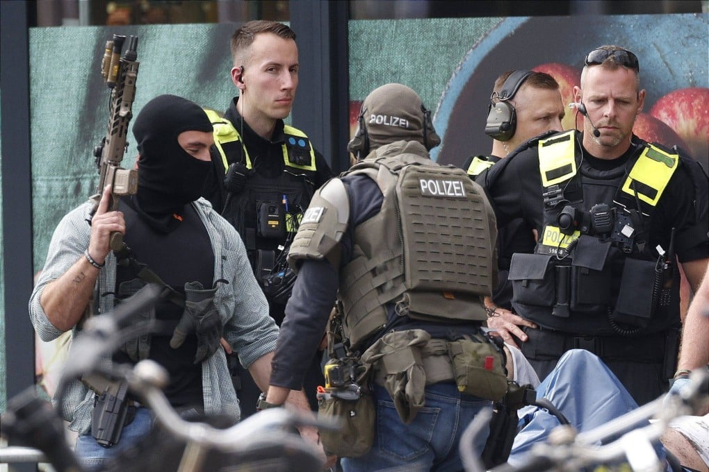 Police and emergency responders outside a supermarket in Berlin, Germany on Sunday. A woman had been held hostage inside the shop since late on Friday. Photo: dpa