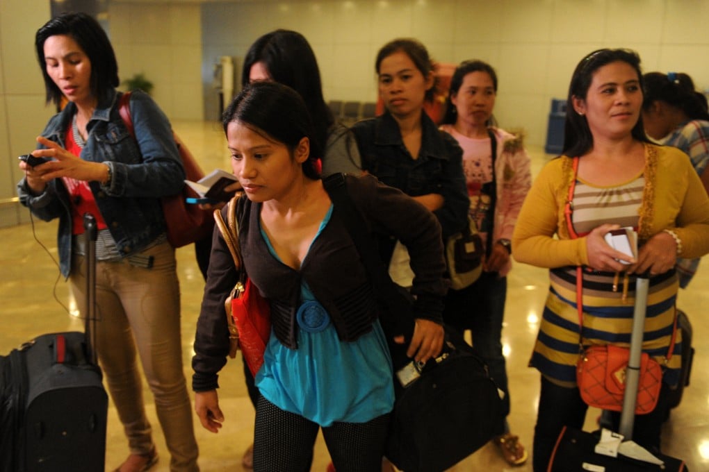 Repatriated Filipino workers arrive in Manila from Saudi Arabia following a crackdown on undocumented workers by Riyadh in 2013. Photo: AFP