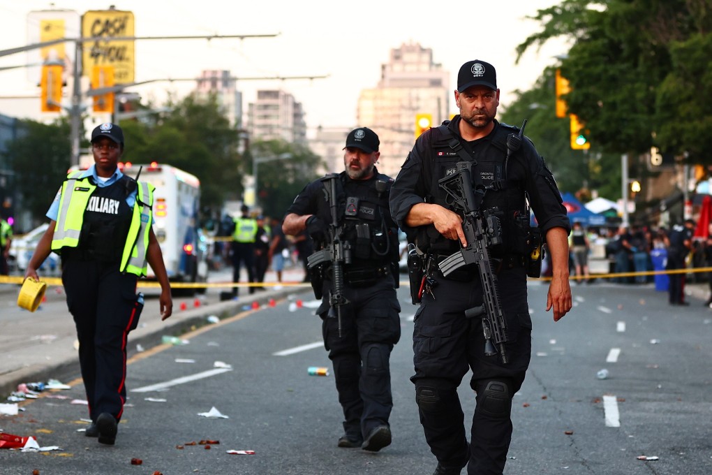 Heavily-armed police at the scene in Toronto on Saturday. Photo: The Canadian Press via AP
