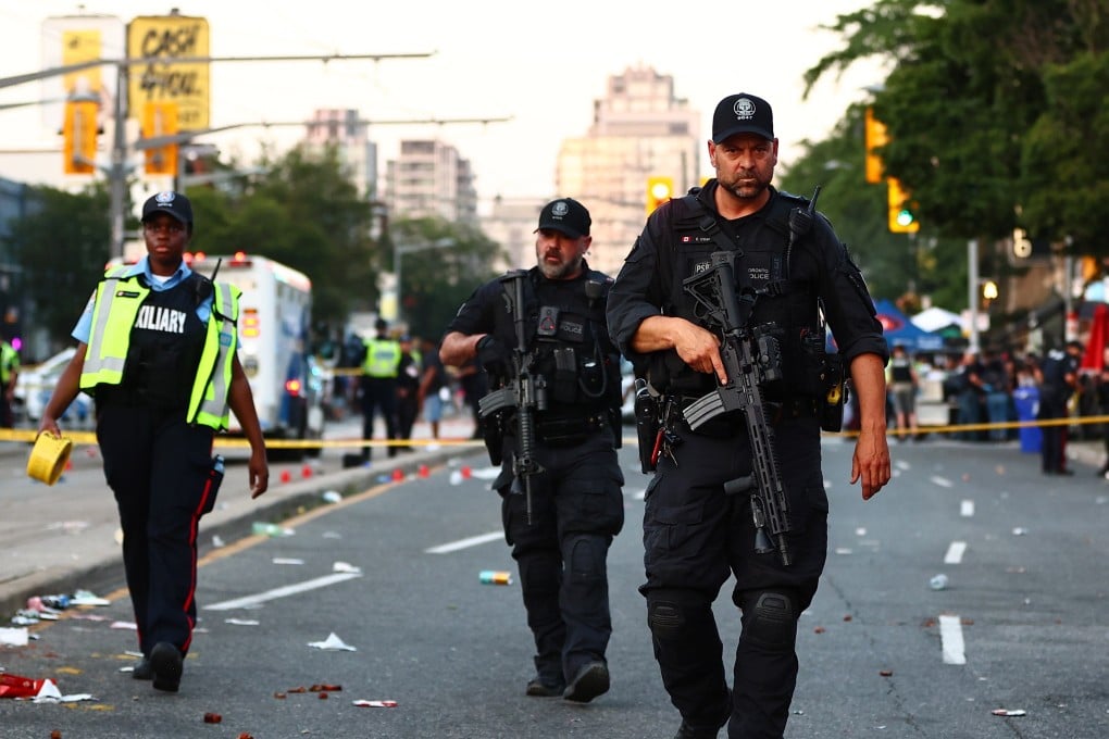 Heavily-armed police at the scene in Toronto on Saturday. Photo: The Canadian Press via AP