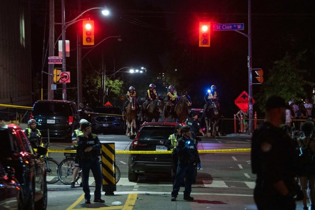 Police officers near the site of a shooting at the Salsa on St Clair Festival in Toronto, Canada on Saturday. Photo: AFP